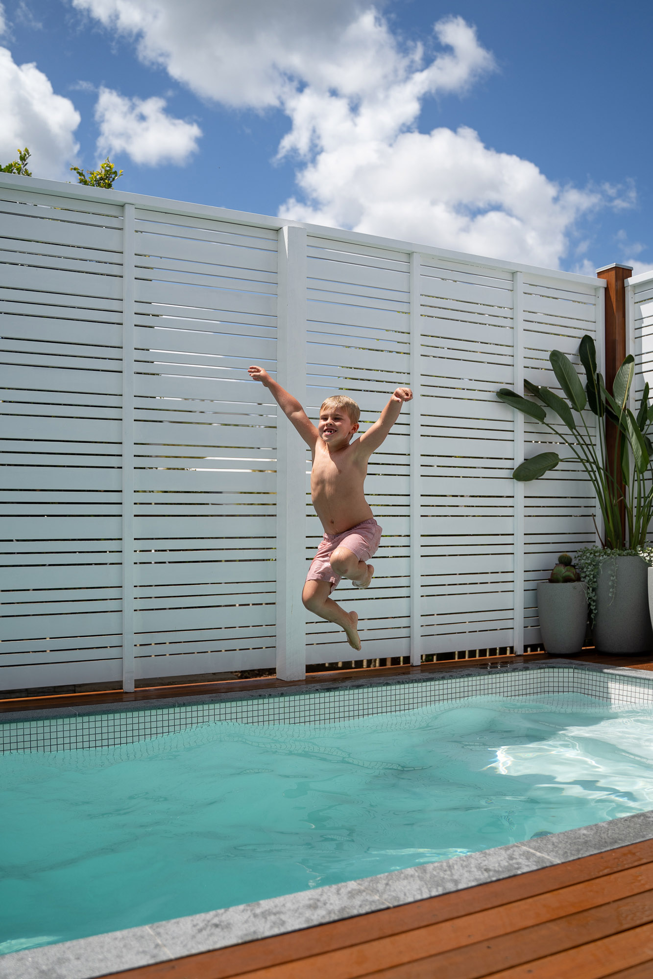 Young boy jumping into Plungie Studio 3.6m x 2.2m plunge pool in Kona Coast