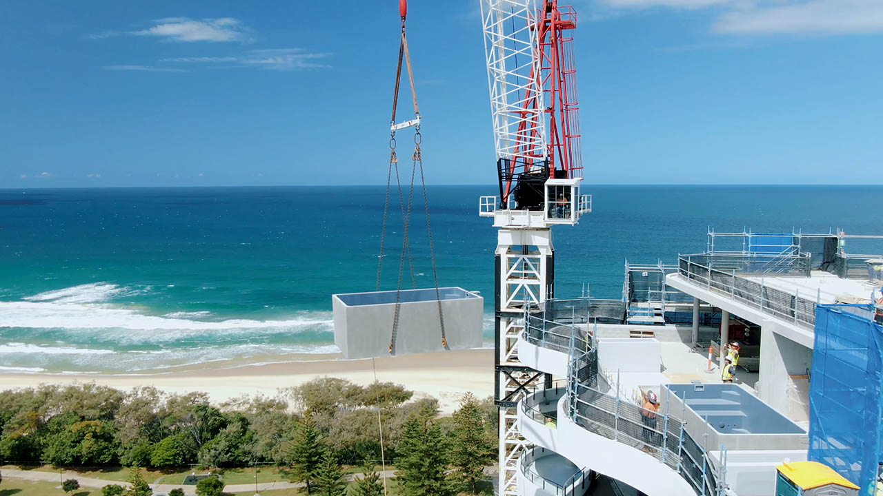 Two 4.6m x 2.5m concrete plunge pools being lifted onto a 17 story development on the Gold Coast